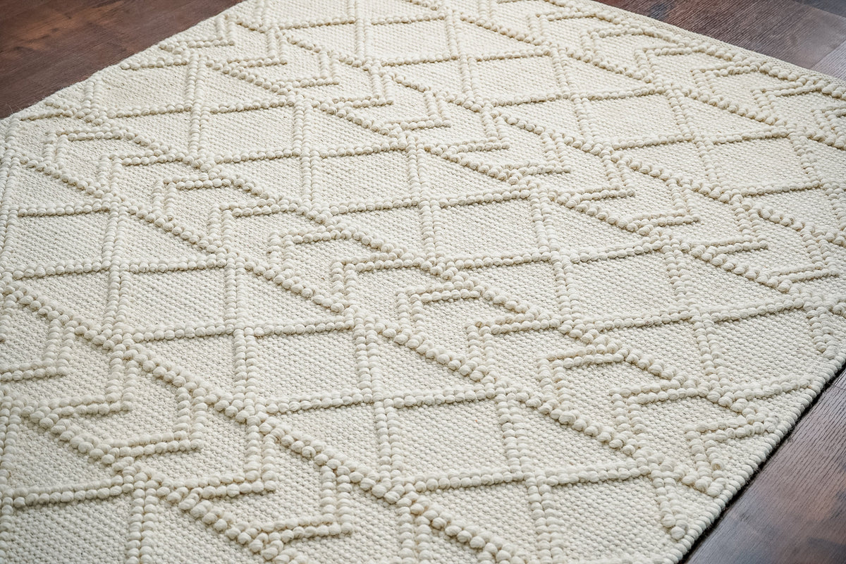 Abstract ivory chunky wool rug weave close-up