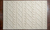 Abstract ivory chunky wool rug in bedroom setting