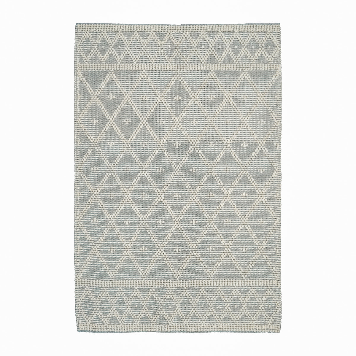 Grey wool rug in a bedroom setting