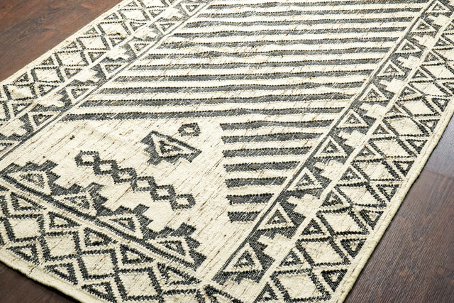 Black and ivory kilim rug styled on a patio