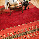 Red kilim rug corner detail showing diamond pattern