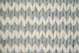 Grey ivory braided rug texture close-up in natural light