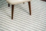 Grey and ivory handwoven wool rug styled in a living room setting