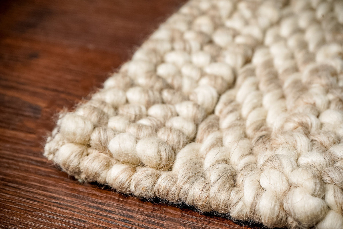 Patterned wool rug styled in a bedroom