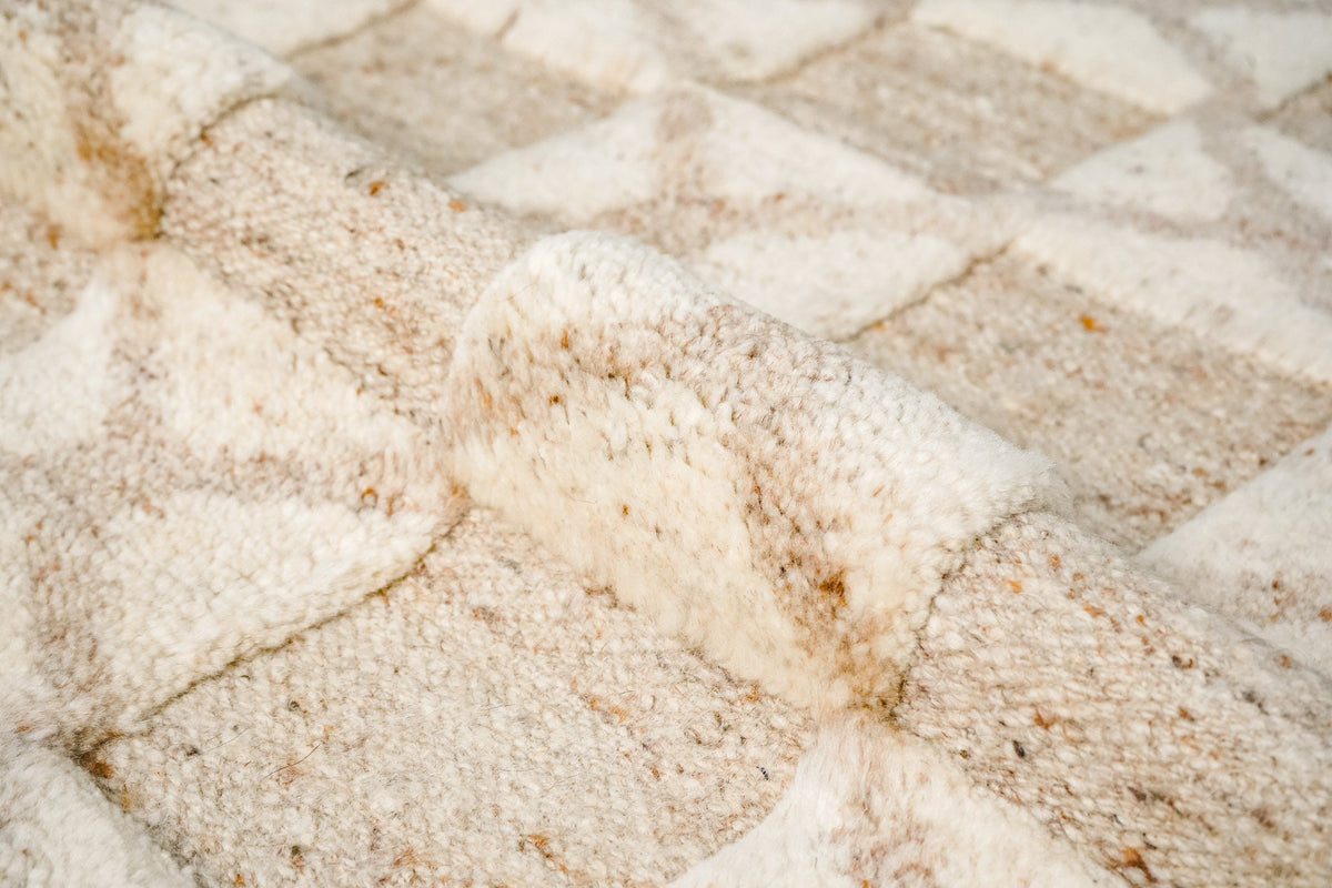 Taupe wool rug shown styled with furniture