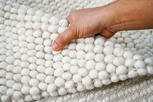 Fluffy ivory chunky loop wool rug, flat lay view