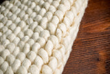 Ivory wool rug pile close-up