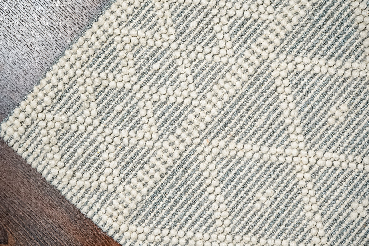 Grey wool rug under natural light