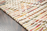 Chunky looped wool rug styled in a Scandinavian living room