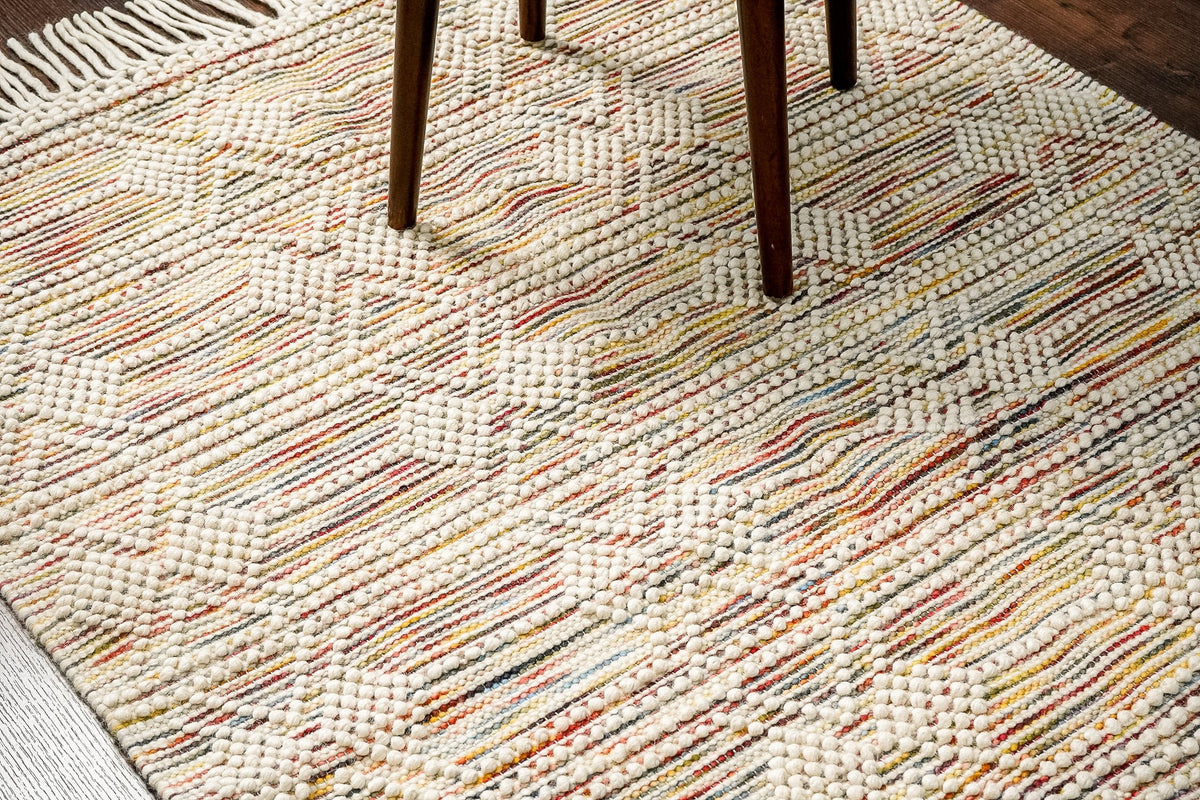 Chunky looped wool rug flat view showing colourful abstract pattern