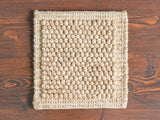 Chunky wool rug styled beside furniture