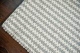Handwoven wool rug shown in a hallway or entryway setting