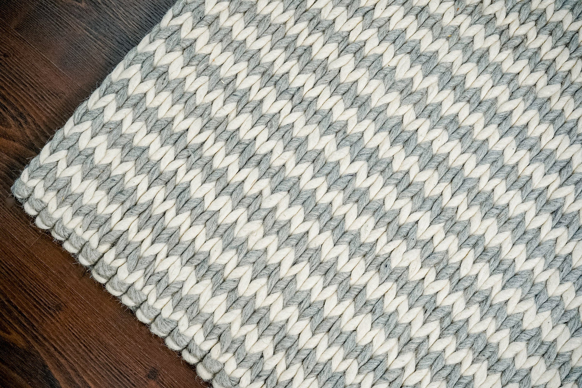 Handwoven wool rug shown in a hallway or entryway setting