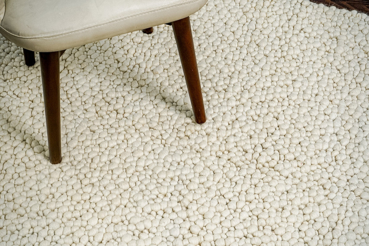 Ivory rug placed under furniture in bedroom