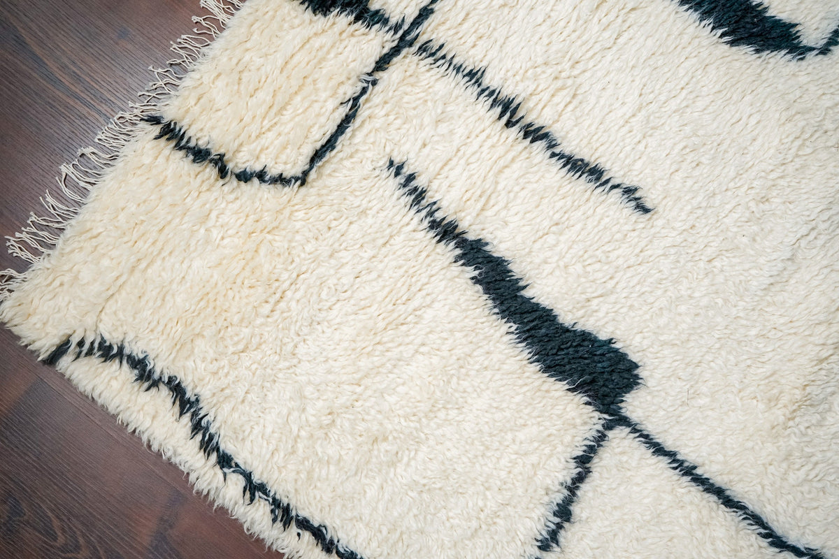 Hand knotted wool rug in a Scandinavian styled bedroom