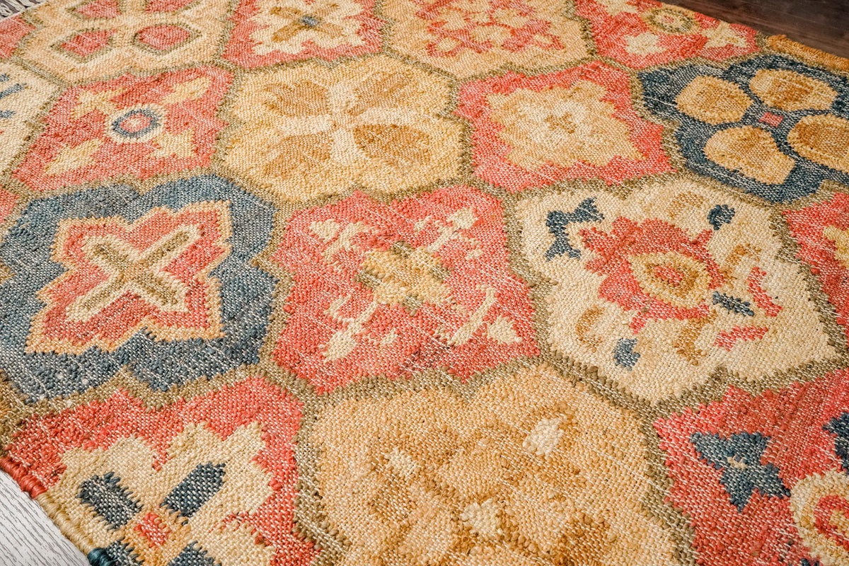 Red jute kilim rug styled in a bohemian bedroom