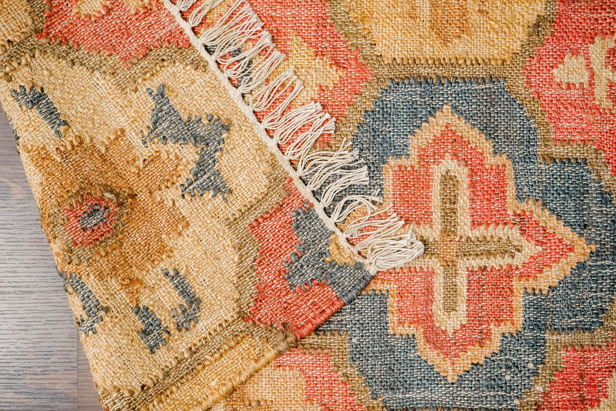 Red jute rug corner and fringe detail