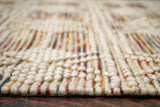 Chunky looped wool rug in a bohemian bedroom setting
