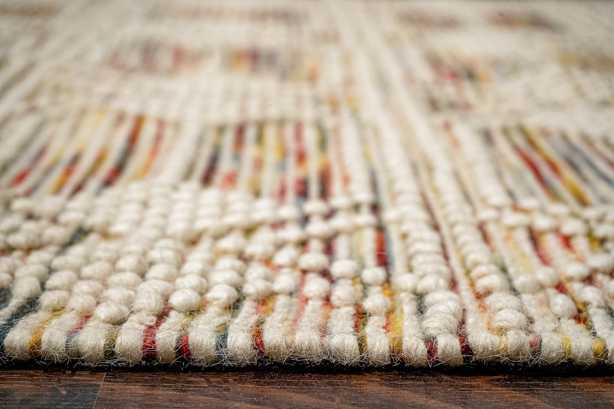 Chunky looped wool rug in a bohemian bedroom setting