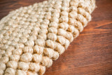 Corner detail of chunky beige rug