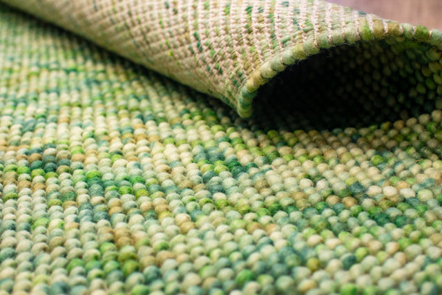 Sage green chunky loop wool rug, flat lay view