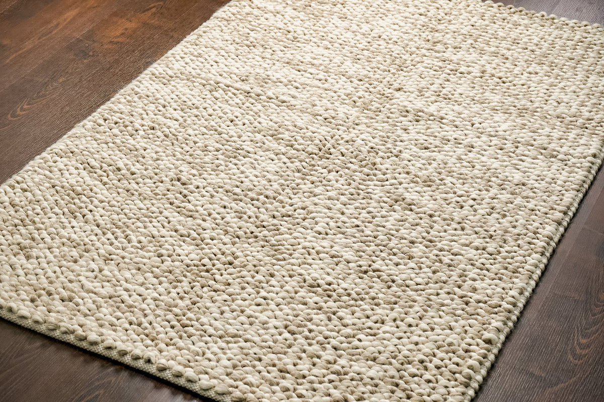 Textured pile close-up of taupe wool rug