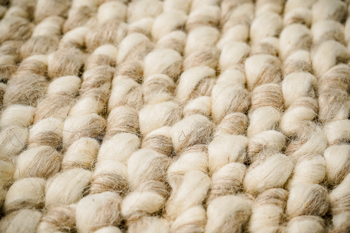 Taupe wool rug corner detail showing weave