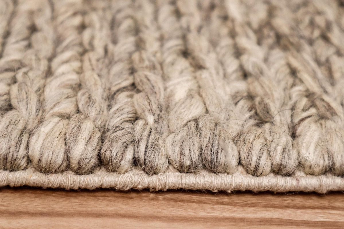 Chunky loop wool rug texture close-up under natural light