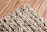Chunky braided wool rug shown at full size on wood flooring