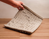 Taupe grey area rug placed in a nordic style hallway