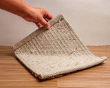 Honeycomb wool rug in a bedroom setting