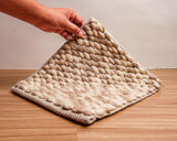 Honeycomb wool rug styled in a living room