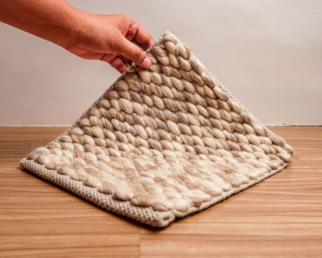 Honeycomb wool rug styled in a living room