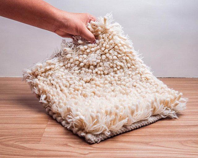 Ivory shaggy wool rug flat view showing high pile