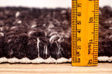Chunky braided wool rug pattern detail close-up