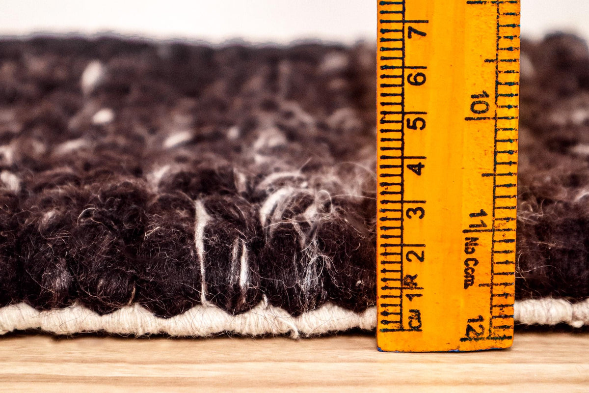 Chunky braided wool rug pattern detail close-up