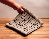 Brown wool rug corner detail showing edge