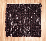 Cola brown wool rug in a bedroom setting