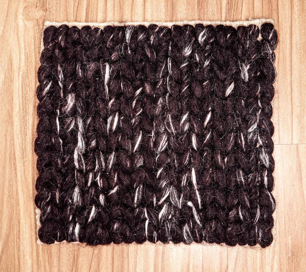 Cola brown wool rug in a bedroom setting