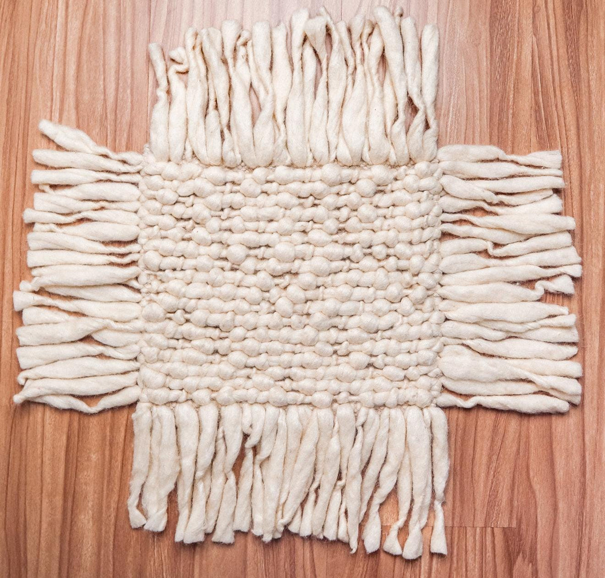 Ivory wool rug fringe edge detail