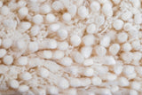 Ivory wool rug fluffy texture close-up
