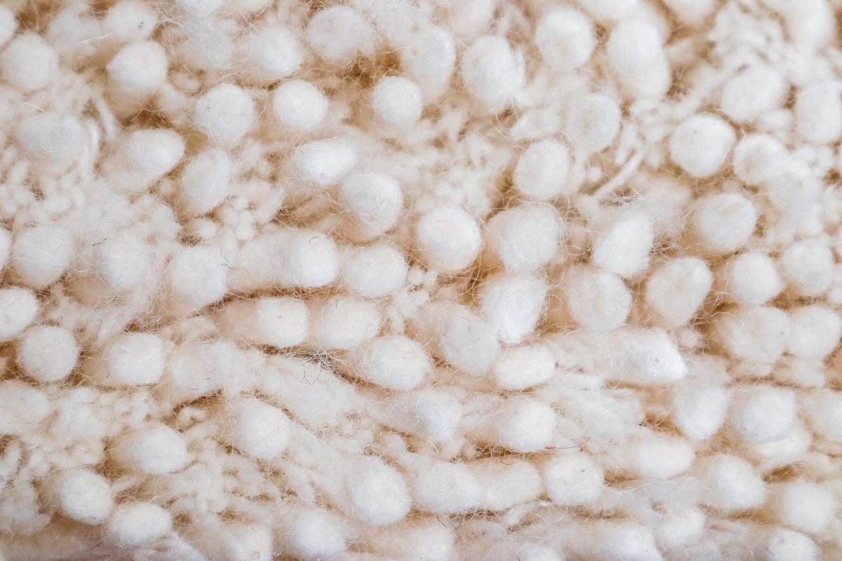 Ivory wool rug fluffy texture close-up
