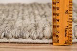 Taupe grey chunky wool rug styled in a modern living room