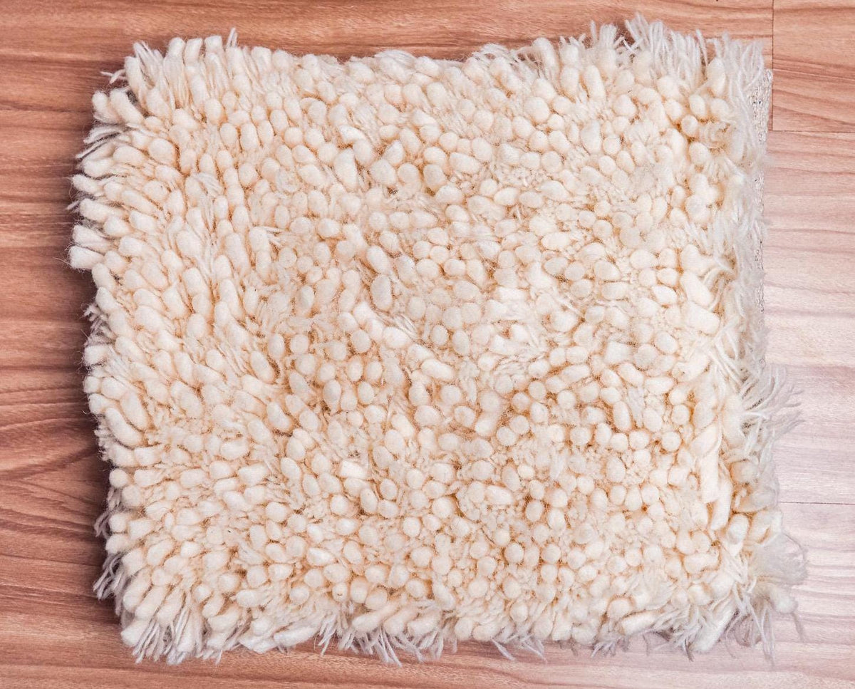 Ivory shag rug in a bedroom setting