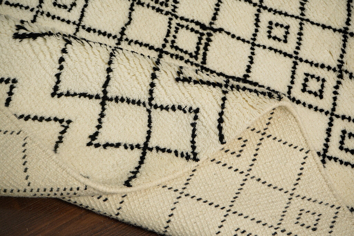 Close-up of hand-knotted Berber texture on ivory rug