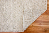 Multi textured wool rug in a bedroom setting