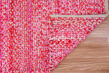 Pink rag rug in a living room setting