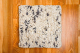 Chunky wool rug texture and color close-up