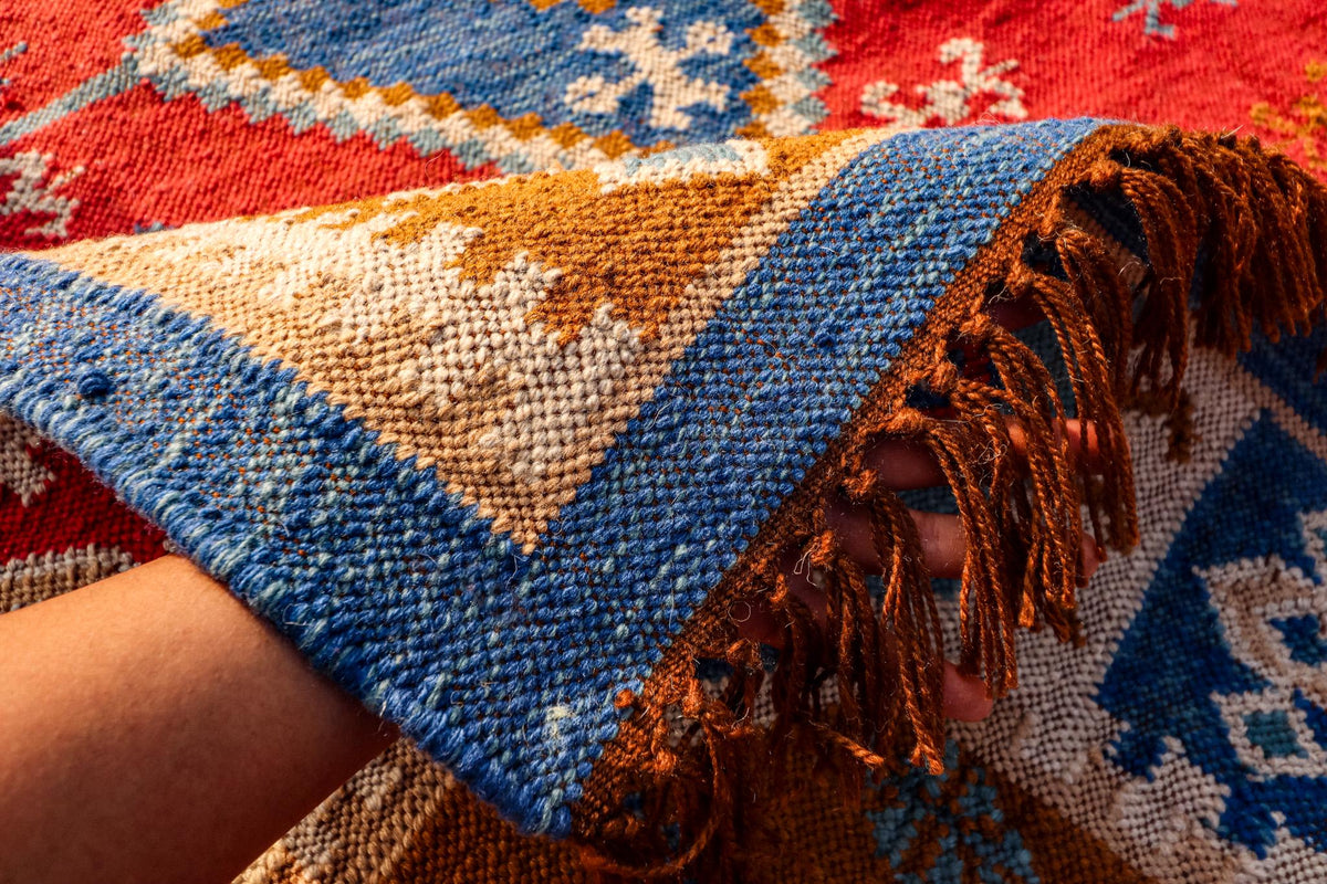 Kilim rug corner detail showing flatweave edge and fringe