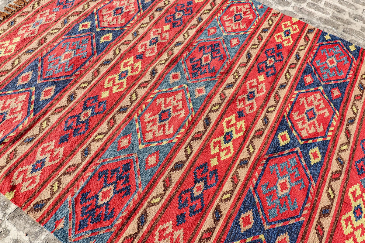 Red Afghan style kilim rug corner detail